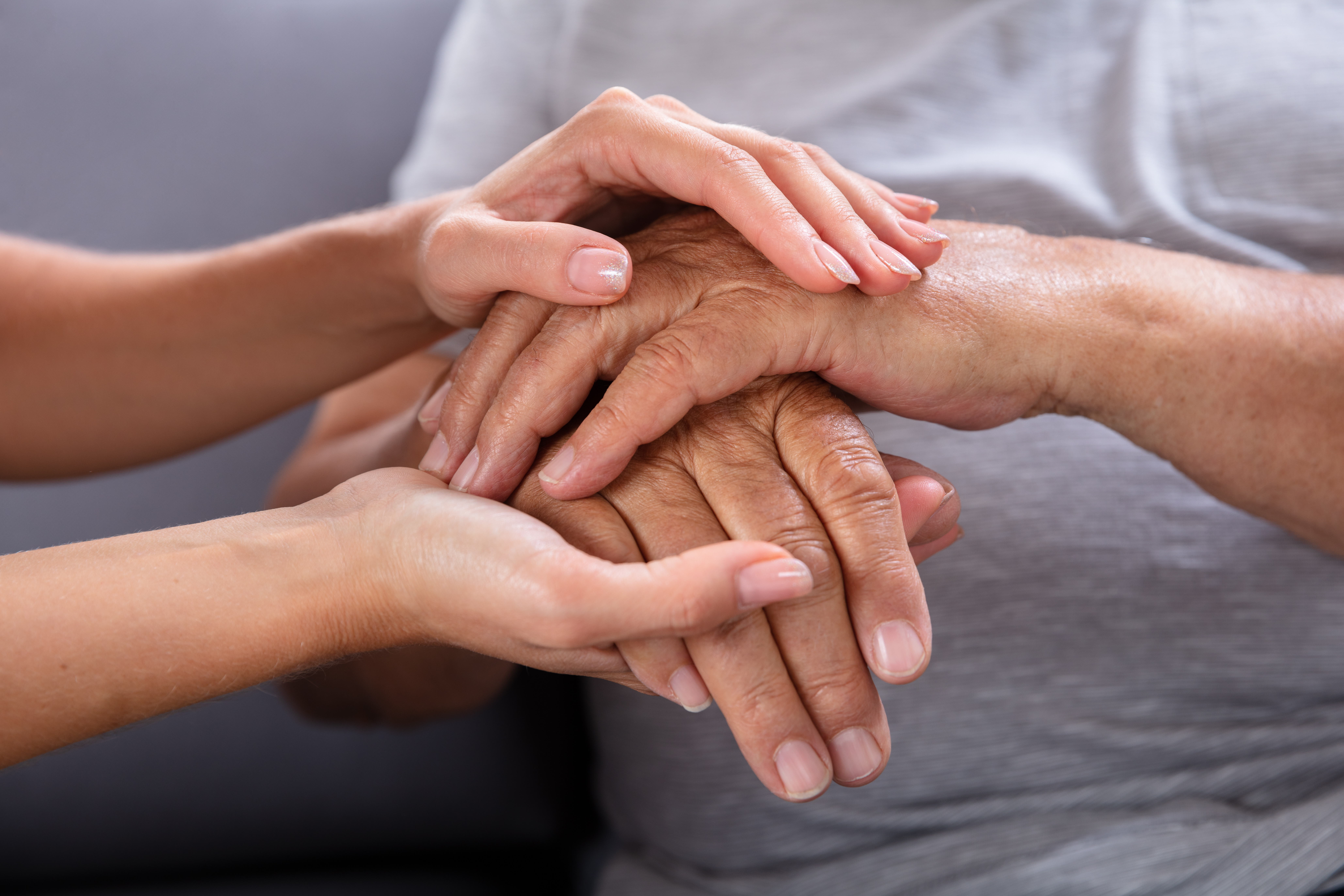 Daughter Holding Her Father's Hand Close-up Of A Daughter Holding Her Elderly Father's Hand